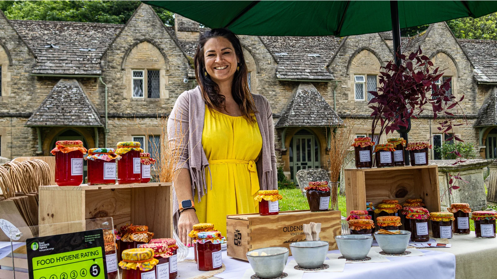 Photo: David Spicer
A stallholder in a yellow dress selling homemade chutneys and preserves at a stall in front of St Mary's Church, Witney, at the Witney Festival of Food and Drink